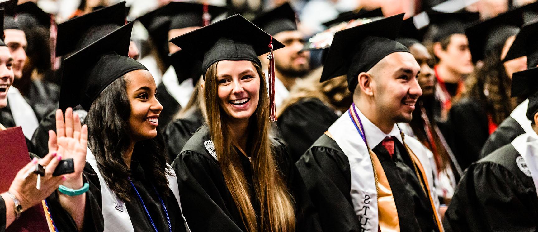 graduates smiling at commencement